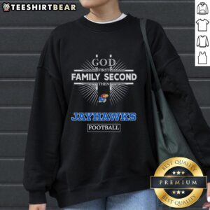 Alt Text: Kansas Jayhawks sweatshirt featuring 'God First, Family Second, Then Jayhawks Football' design in vibrant colors.