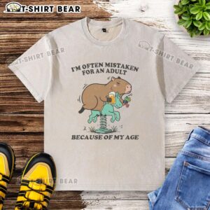 Capybara wearing a washed t-shirt, often mistaken for an adult due to its age, showcasing its unique personality.