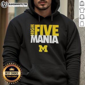 Man in a Michigan Wolverines hoodie giving a high five, showcasing team spirit and style in a fun atmosphere.
