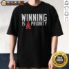 Nice Los Angeles Angels Winning Is Angels Priority T-Shirt showcasing the team's logo and vibrant colors for fans.