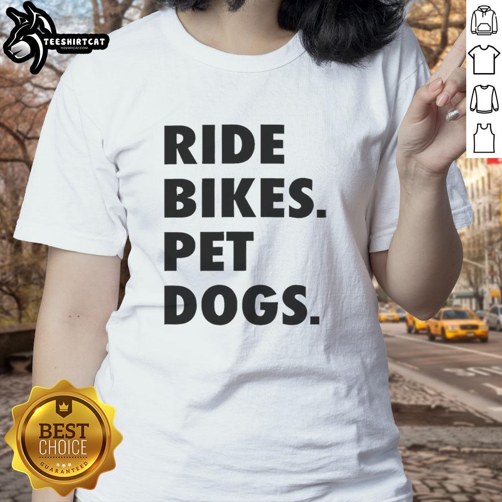 nice-ride-bikes-pet-dogs-ladies-tee Two ladies enjoying a Nice Ride on bikes with their pet dogs, showcasing a fun outdoor adventure in a sunny park.