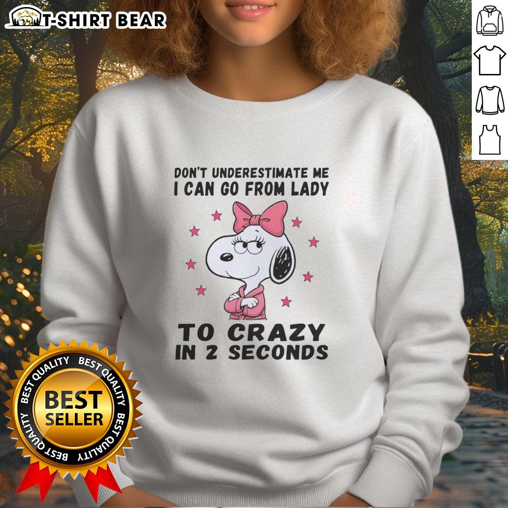 Nice Snoopy Don't Underestimate Me I Can Go From Lady To Crazy In 2 Seconds Sweatshirt Snoopy sweatshirt with 'Don't Underestimate Me' quote, showcasing playful design and vibrant colors.