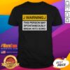 Nice Warning - May Break Into Song T-Shirt featuring playful text on a vibrant background, perfect for music lovers.