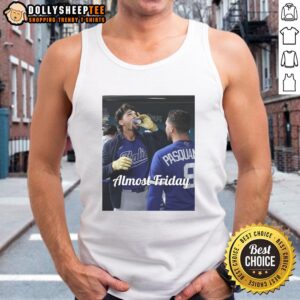 Jac Caglianone of the Kansas City Royals enjoying espresso in the dugout, wearing 'Almost Friday' tank top.