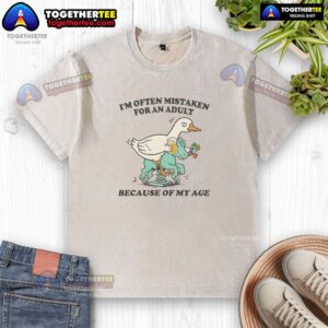 Top I'm Often Mistaken For An Adult Because Of My Age Duck Washed T-Shirt displayed on a hanger in a bright room.