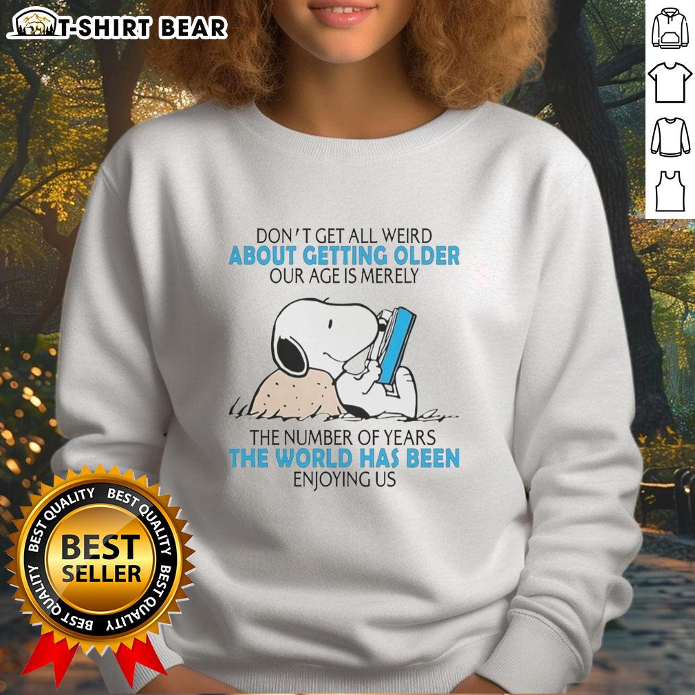 Official Snoopy Don't Get All Weird About Getting Older Our Age Is Merely The Number Of Years Sweatshirt Alt Text: Official Snoopy sweatshirt featuring Don't Get All Weird About Getting Older design, celebrating aging with humor.
