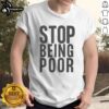 Alt Text: Official Stop Being Poor T-Shirt featuring bold text design, perfect for expressing financial empowerment and humor.