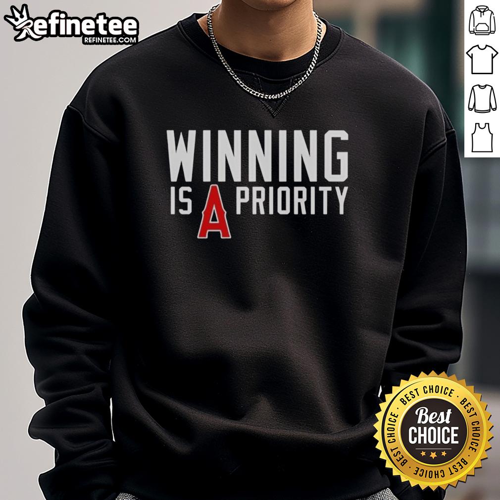 original-los-angeles-angels-winning-is-angels-priority-sweatshirt Original Los Angeles Angels 'Winning is Angels Priority' sweatshirt featuring team colors and logo, perfect for fans.
