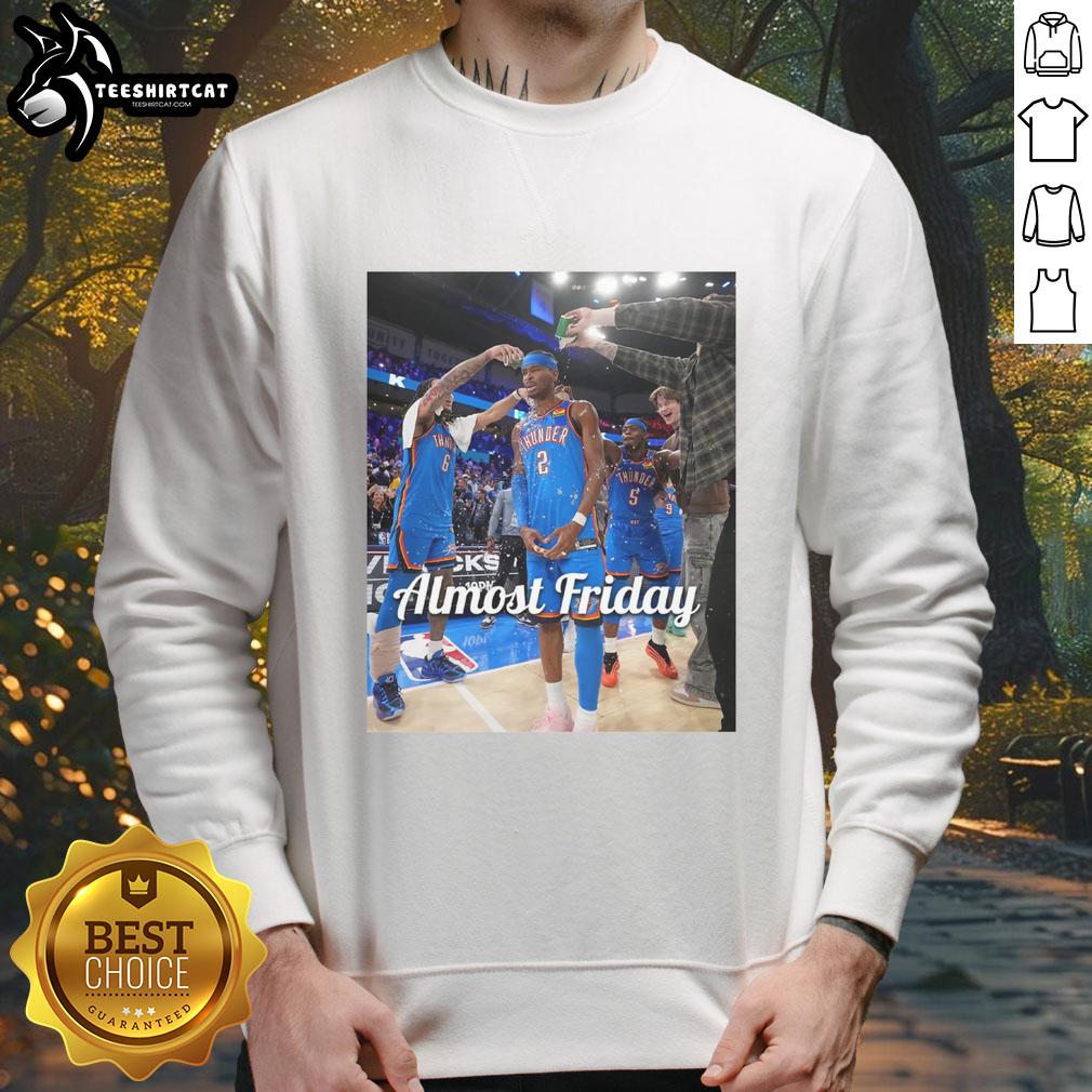original-shai-gilgeous-alexander-oklahoma-city-thunder-almost-friday-postgame-sweatshirt Shai Gilgeous-Alexander in an Oklahoma City Thunder sweatshirt, celebrating after a game, showcasing team pride.