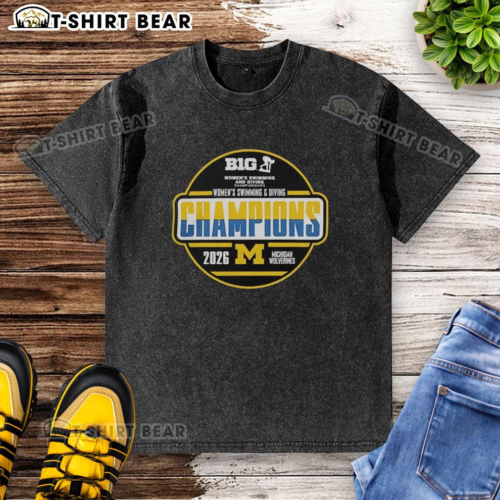 Pretty Michigan Wolverines Women's Swimming And Diving Big Ten Champions 2026 Washed T-Shirt Pretty Michigan Wolverines Women's Swimming and Diving Big Ten Champions 2026 washed t-shirt displayed on a hanger.