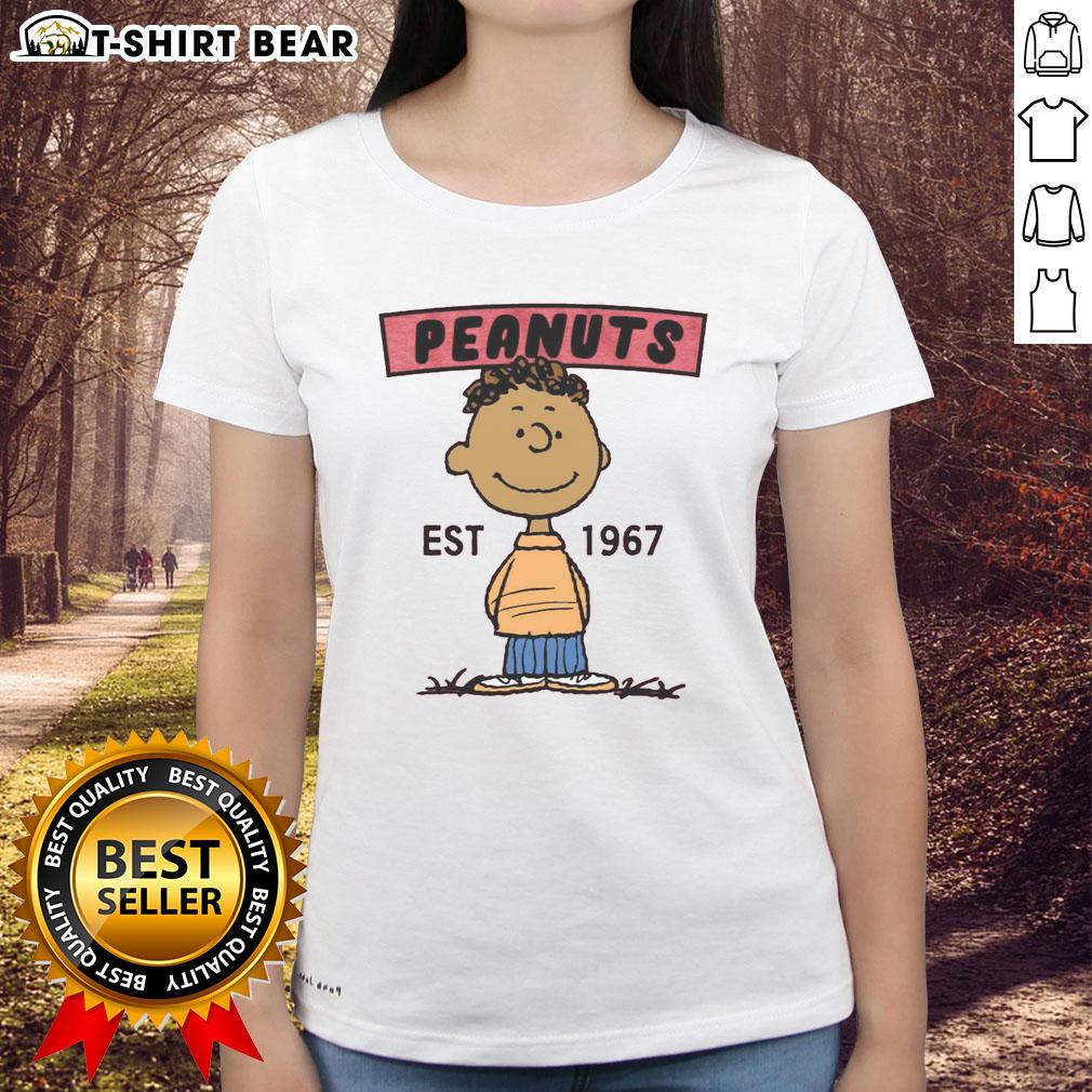 Pretty Peanuts Franklin Est 1967 Ladies Tee Pretty Peanuts Franklin Est 1967 Ladies Tee featuring a stylish graphic design of Franklin from Peanuts.
