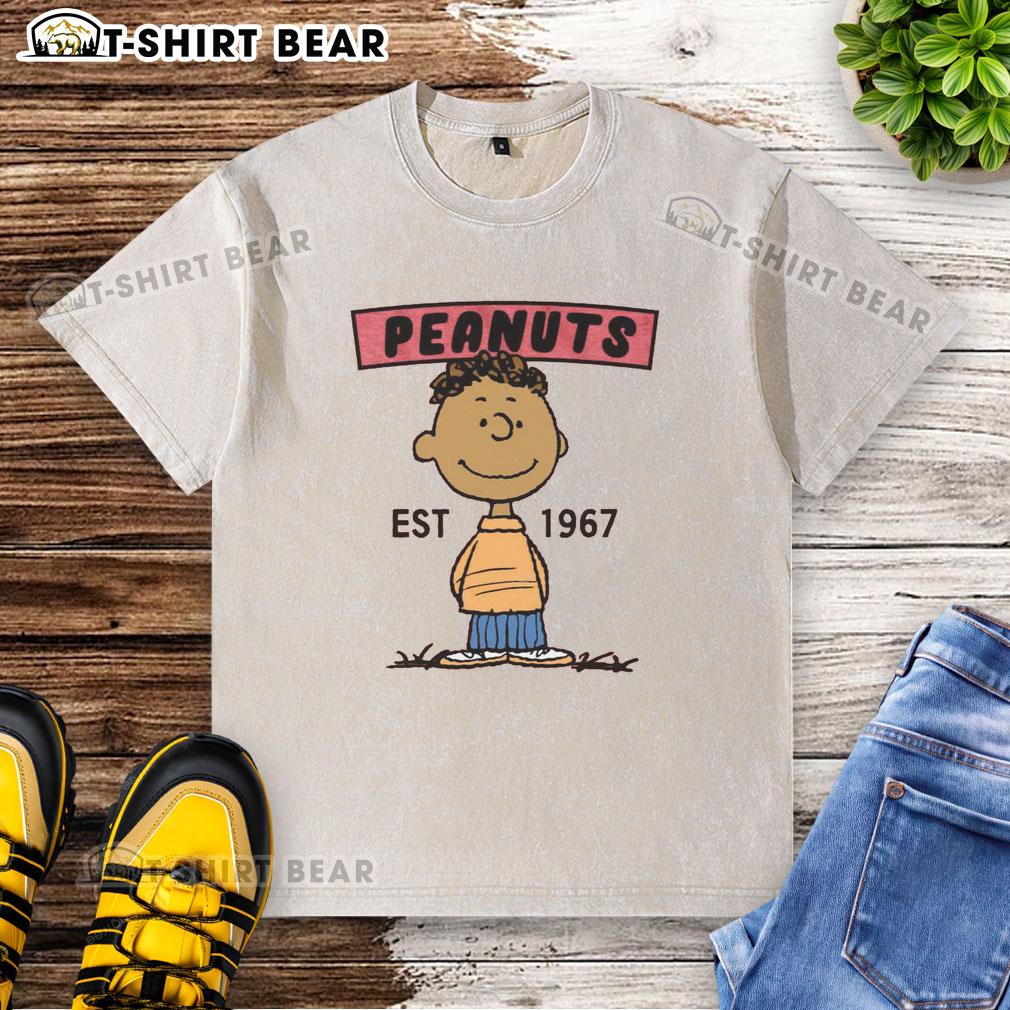 Pretty Peanuts Franklin Est 1967 Washed T Shirt Pretty Peanuts Franklin Est 1967 washed t-shirt featuring a vintage design of Franklin from Peanuts comics.