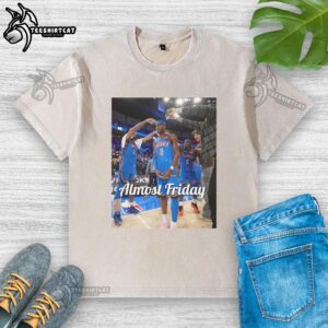 Shai Gilgeous-Alexander in an Oklahoma City Thunder 'Almost Friday' postgame washed t-shirt, showcasing team spirit.