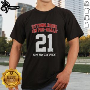 Alt Text: Premium Ottawa Runs On Foe Goals 21 Give Him The Puck T-Shirt showcasing a stylish hockey-themed design for fans.