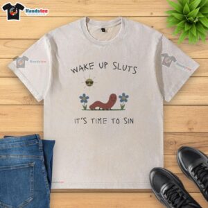 Premium Nicolas Vansteenberghe 'Wake Up Sluts It's Time to Sin' washed t-shirt displayed on a hanger, showcasing stylish design.