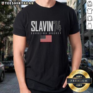 Alt Text: Top Jaccob Slavin 74 Carolina Hurricanes USA Flag Elite T-Shirt featuring vibrant design and team colors.