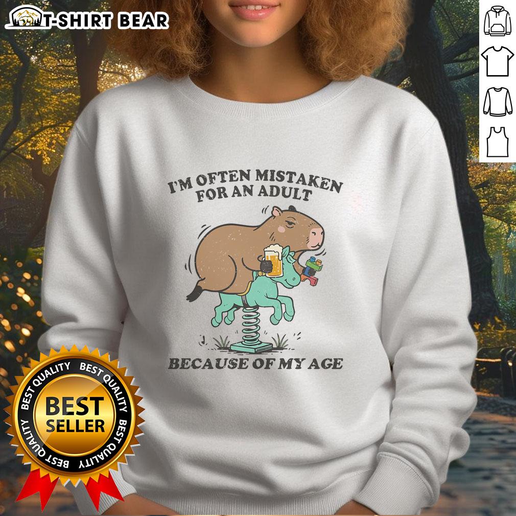 Top I'M Often Mistaken For An Adult Because Of My Age Capybara Sweatshirt Capybara sweatshirt featuring the phrase 'Top I'm Often Mistaken For An Adult Because Of My Age' in stylish font.