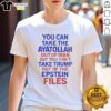 Alt Text: Humorous t-shirt with the phrase 'You Can Take The Ayatollah Out Of Iran But You Can't Take Trump Out Of The Epstein Files.'