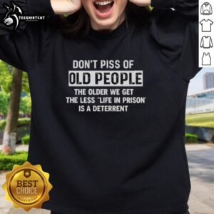 Alt Text: Premium sweatshirt featuring the phrase Don't Piss Off Old People with humorous text about aging and prison deterrents.