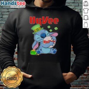 Alt Text: Cute Stitch hugging the Hy-Vee logo on a stylish St. Patrick's Day hoodie, perfect for festive celebrations.