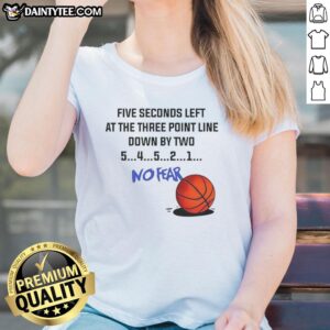 Lady shooting a three-pointer in basketball, wearing 'No Fear' tee, down by two with five seconds left on the clock.