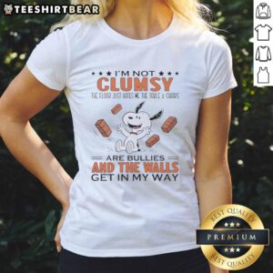 Alt Text: Funny ladies tee featuring Snoopy with the phrase 'I'm Not Clumsy, The Floor Just Hates Me' and playful design.