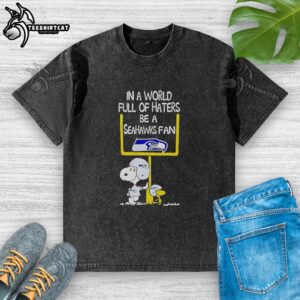 Alt Text: Premium Snoopy in a world full of haters, be a Seahawks fan washed t-shirt featuring Snoopy in Seahawks gear.