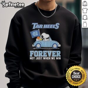 Alt Text: Cozy sweatshirt featuring Snoopy and Woodstock diving, celebrating North Carolina Tar Heels spiritperfect for fans!