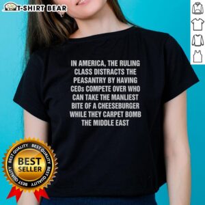 Original In America tee depicting ruling class distractions while carpet bombing the Middle East, perfect for bold statements.