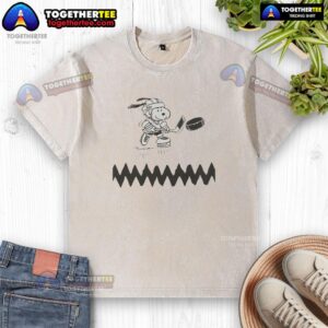 Top Snoopy dog hockey player graphic on a washed t-shirt, perfect for fans of hockey and Snoopy merchandise.