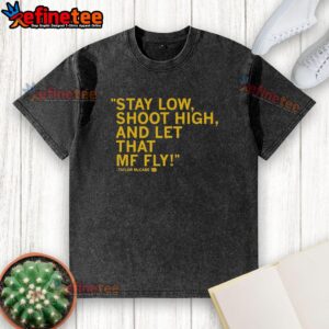 Original Taylor McCabe Stay Low Shoot High and Let That MF Fly washed t-shirt displayed on a wooden background.