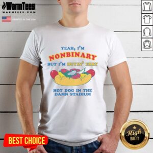 Alt Text: Nonbinary person wearing a Good Yeah I'm Nonbinary But I'm Buyin' Erry Hot Dog In The Stadium T-shirt at a game.