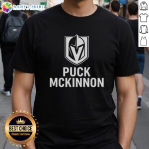 Alt Text: Top Vegas Golden Knights Ice Hockey Puck McKinnon Logo T-Shirt featuring bold graphics and team colors for fans.