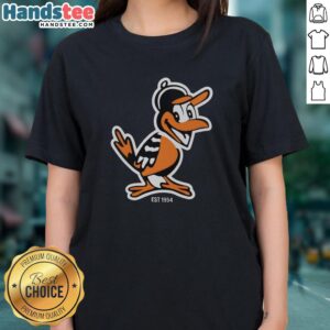 Nice Zay wearing a Baltimore Orioles mascot tee, celebrating the team's legacy since 1954 with stylish floral accents.