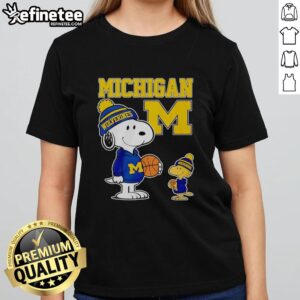 Alt Text: Original Snoopy and Woodstock in Michigan Wolverines jerseys on a ladies tee, perfect for fans and collectors.