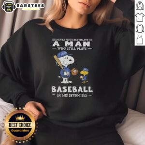 Alt Text: Cute Peanuts x Toronto Blue Jays sweatshirt featuring Never Underestimate A Man Who Still Plays Baseball In His Seventies.