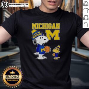 Alt Text: Snoopy and Woodstock in Michigan Wolverines jersey t-shirt, showcasing team spirit in a fun cartoon design.