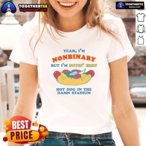 Nonbinary person wearing 'Awesome Yeah I'm Nonbinary' ladies tee, enjoying hot dogs at a stadium event.