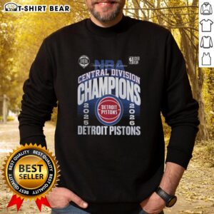 Alt Text: 2026 Central Division Champions sweatshirt celebrating the Detroit Pistons, displayed in a locker room setting.