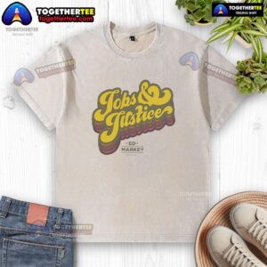 Good Jobs and Justice logo on a washed t-shirt, promoting fair labor practices and social equity.