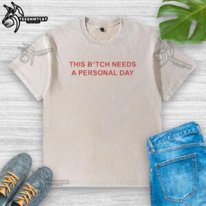 Alt Text: Official This Bitch Needs A Personal Day washed t-shirt featuring a relaxed fit and bold graphic design.