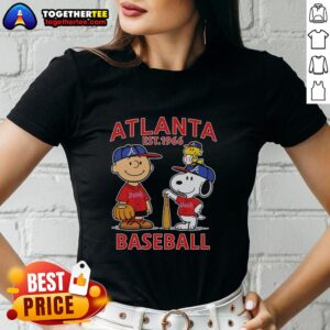 Alt Text: Charlie Brown, Snoopy, and Woodstock in an Atlanta Braves baseball jersey, Est. 1961, featured on a ladies' tee.