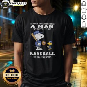 Alt Text: Cute Peanuts X Toronto Blue Jays t-shirt featuring the phrase Never Underestimate A Man Who Still Plays Baseball In His Seventies.