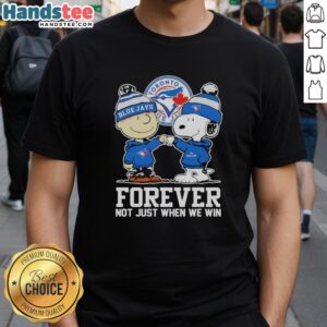 Alt Text: Cute Charlie Brown fist pump with Snoopy wearing Toronto Blue Jays Forever shirt, celebrating team spirit.