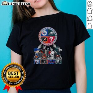 Original Philadelphia Sports Teams Snoopy graphic tee featuring 76ers, Eagles, Flyers, and Phillies for ladies.