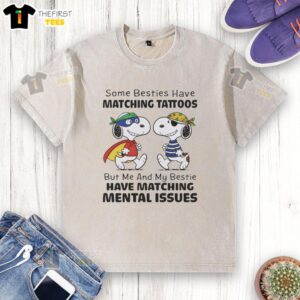 Alt Text: Cute Snoopy washed t-shirt featuring 'Some besties have matching tattoos, but me and my bestie have matching mental issues.'