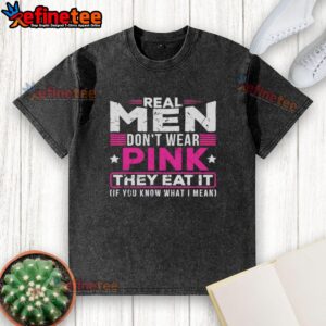 Original Real Men Don't Wear Pink They Eat It T-Shirt in washed style, featuring a humorous graphic design.
