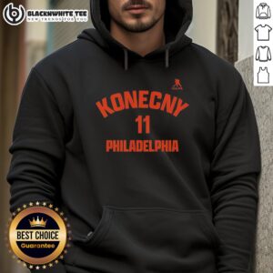 Travis Konecny wearing a stylish Philadelphia Flyers hoodie, showcasing team pride and sporty fashion in vibrant colors.