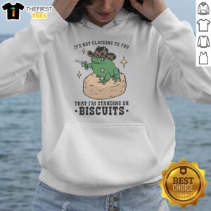 Pretty frog cowboy holding a pistol, standing on biscuits, wearing a hoodie - fun and quirky character design.