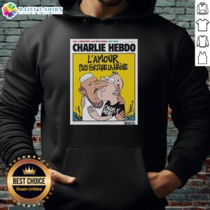 Two men kissing while wearing the 'L'Amour Plus Fort Que La Haine' hoodie from Charlie Hebdo, symbolizing love over hate.